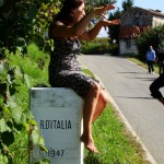 Elena Orzan is an expert on wines from northeast Italy. In this photo, she is sitting on the border of Italy and Slovenia.